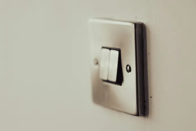 white light switch on white painted wall